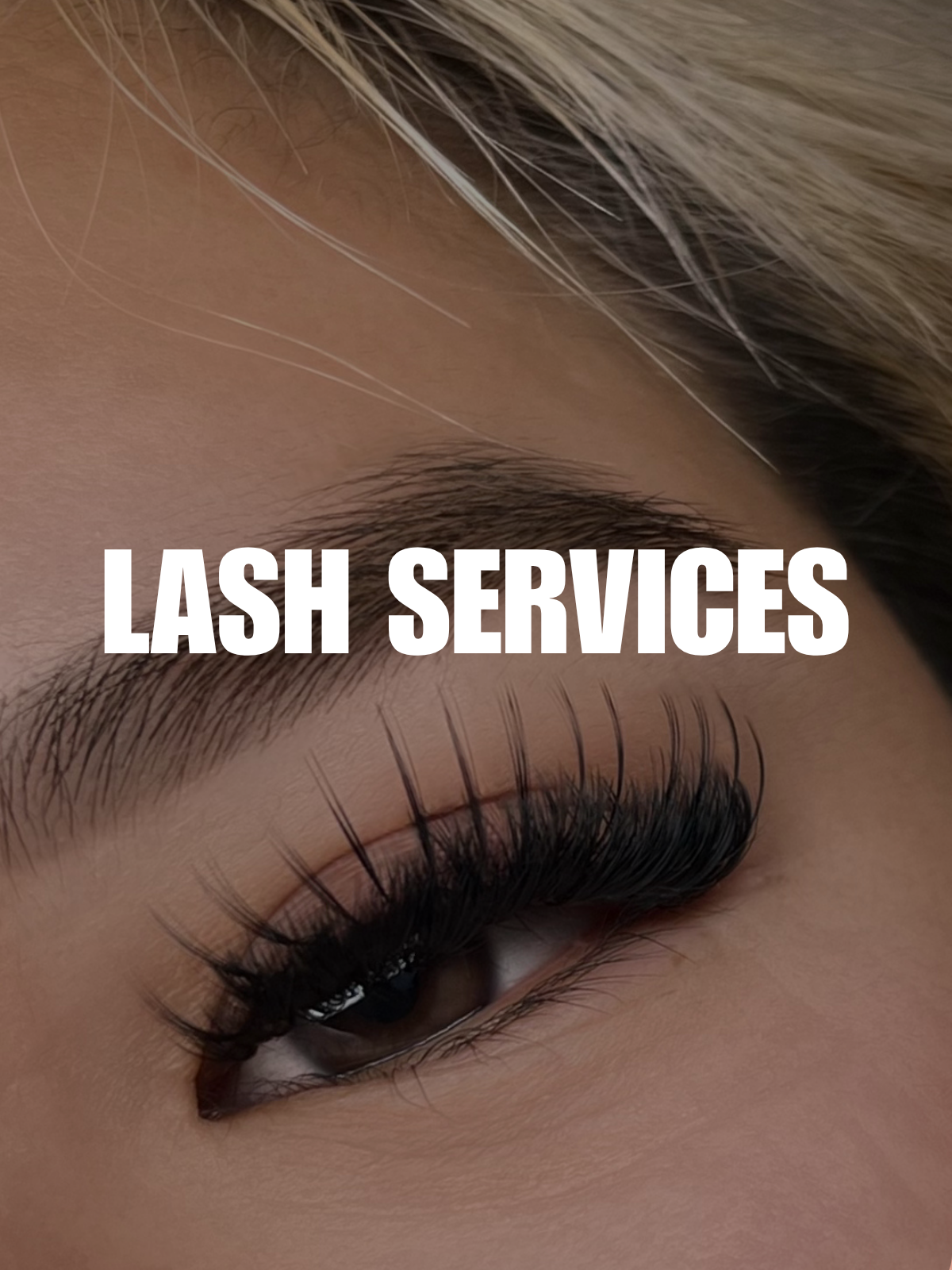 Close-up of a woman's eye with long, dark false eyelashes and a defined eyebrow, with the text 'LASH SERVICES' overlaid across the center.